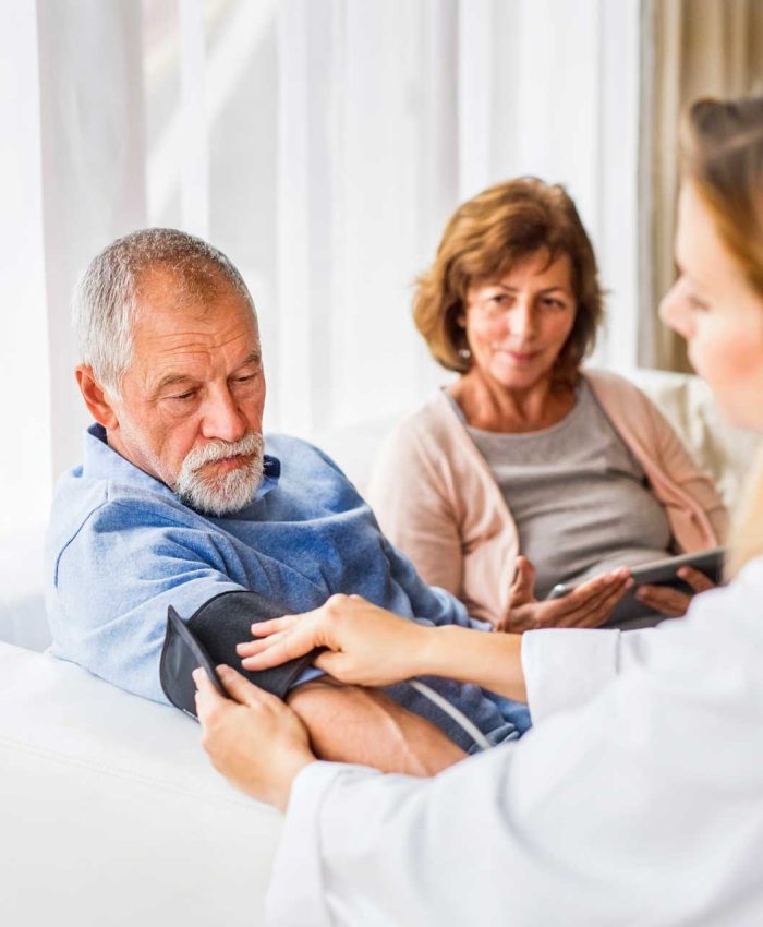 female-doctor-checking-blood-pressure-of-senior-ma-PDN3YZZ.jpg